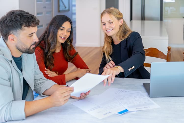 Agent and clients reviewing papers Agent and clients reviewing papers