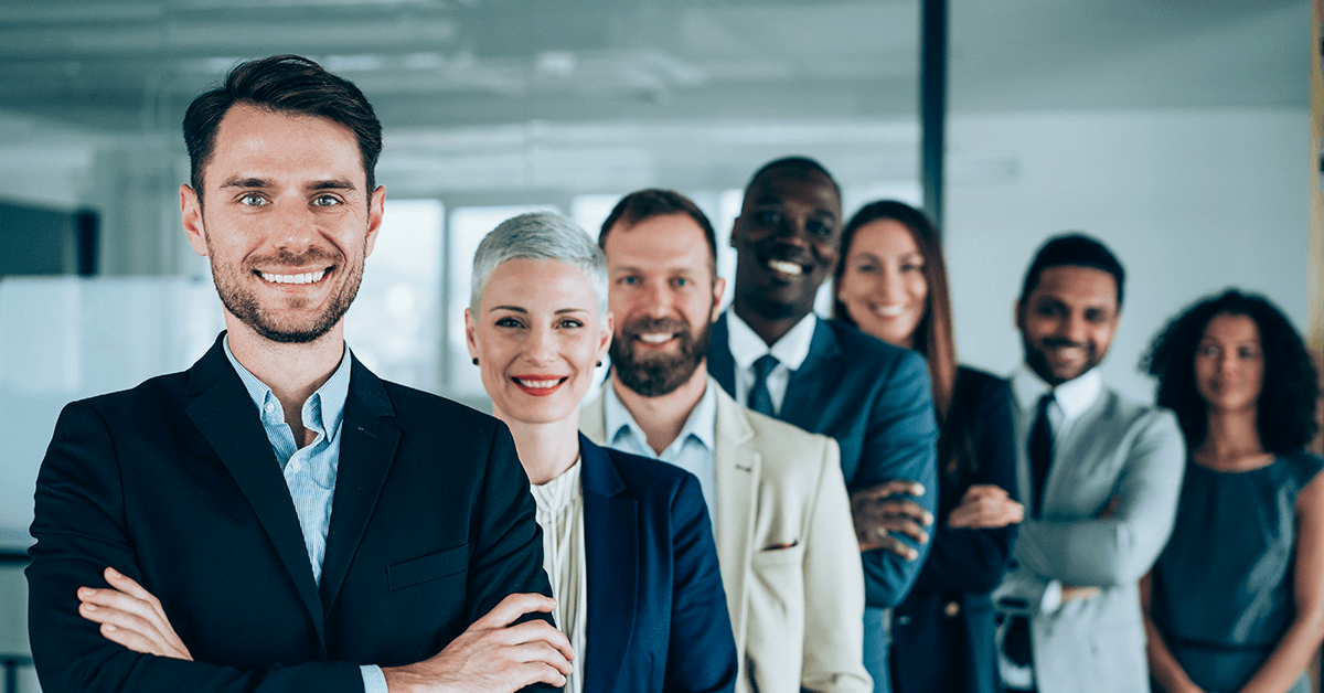 Confident Businessman with His Team Behind Him Representing the Texas REALTOR® Leadership Team Gathering in Austin, TX