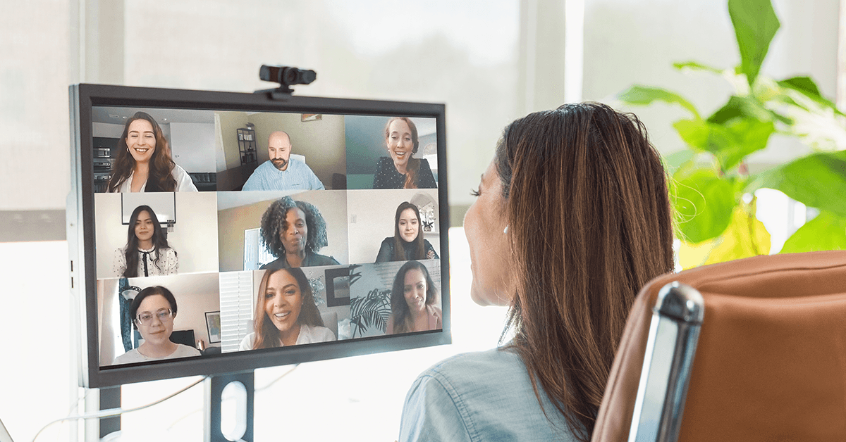 Over the Shoulder View of a Woman on a Video Conference Call on a Computer Monitor Representing Texas REALTOR® Executive Board Conduct Virtual Training