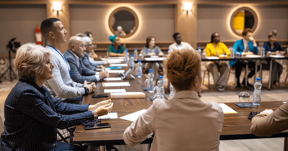 Participants in a Business Conference Around a Table Representing the Texas REALTOR® New Trustee Orientation