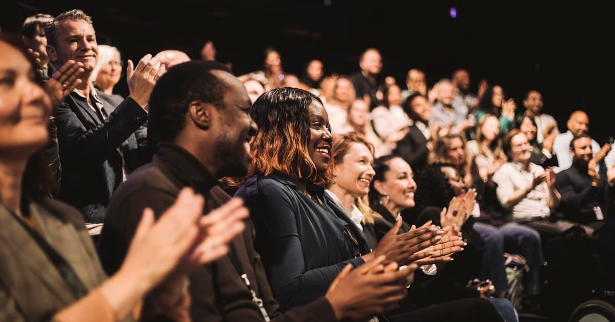 Side Angle View of an Audience in Profile Clapping Representing Canopy REALTORS® Broker Summit