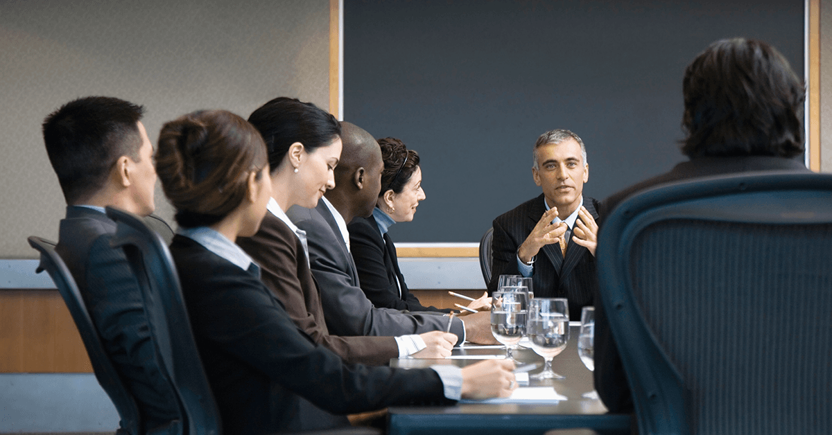 Office Workers Meeting in a Conference Room Representing the Texas REALTORS® New AE Orientation