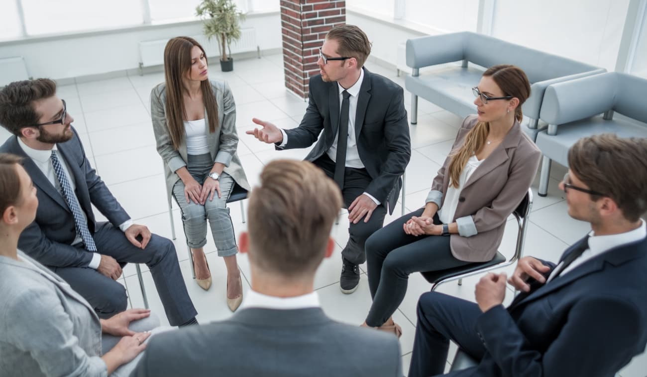 Board members sitting in a circle in a meeting