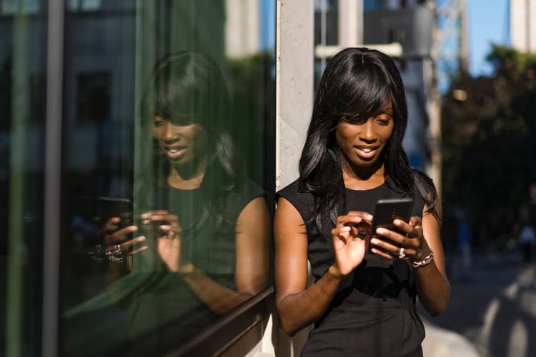 Businesswoman using smartphone in city