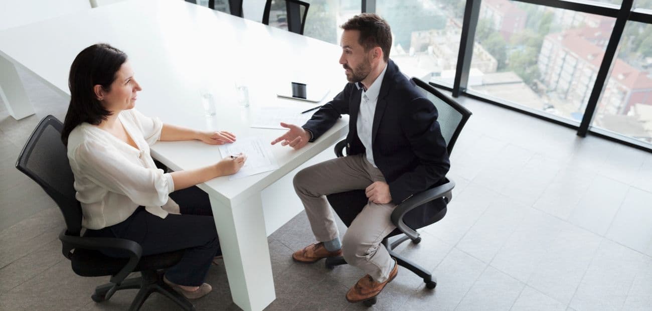Man and woman in a conference room for an interview