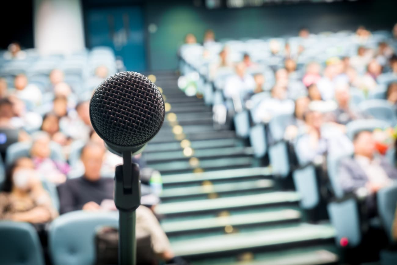 Microphone in auditorium with blurry crowd