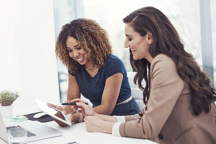 Businesswomen looking at a tablet Businesswomen looking at a tablet