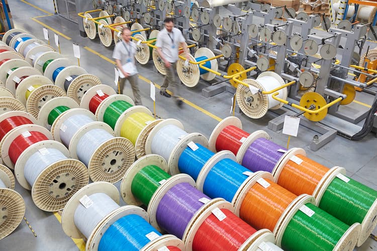 Colorful spools of optic cables in a factory Colorful spools of optic cables in a factory