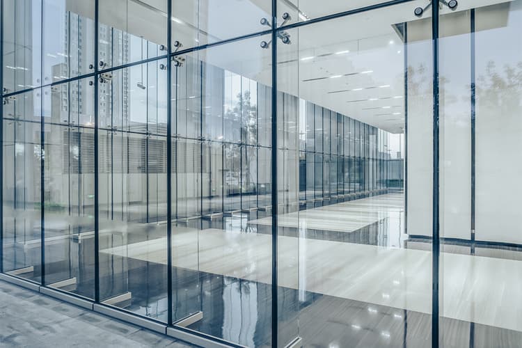 Commercial building corridor seen through glass walls Commercial building corridor seen through glass walls
