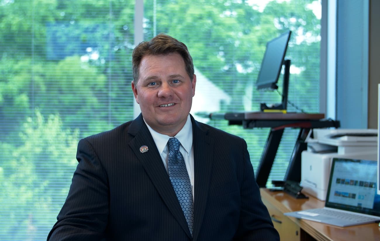 Kipp Cooper seated at desk
