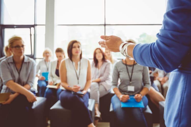 Professionals attending training, listening to instructor
