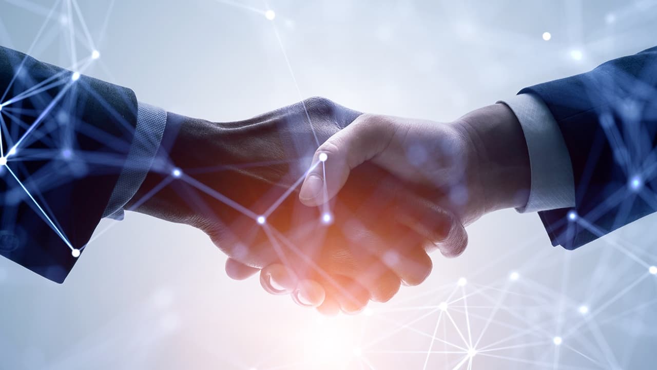 Business handshake with networking concept
