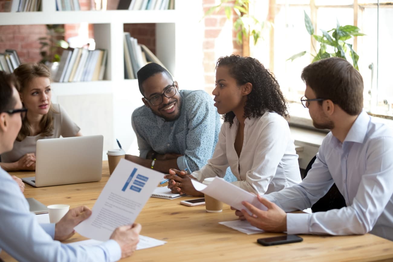 Diverse colleagues discussing at a committee meeting