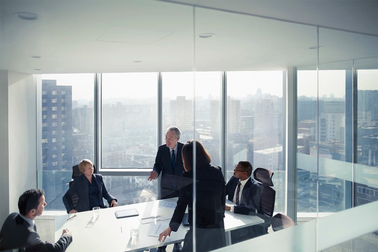 Group of executives meeting in an office conference room Group of executives meeting in an office conference room
