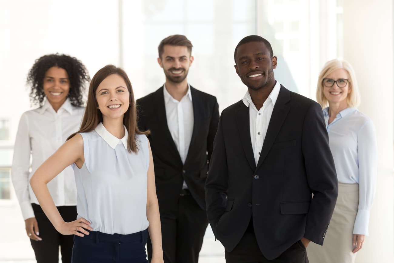 Group of people posing for portrait in business attire.