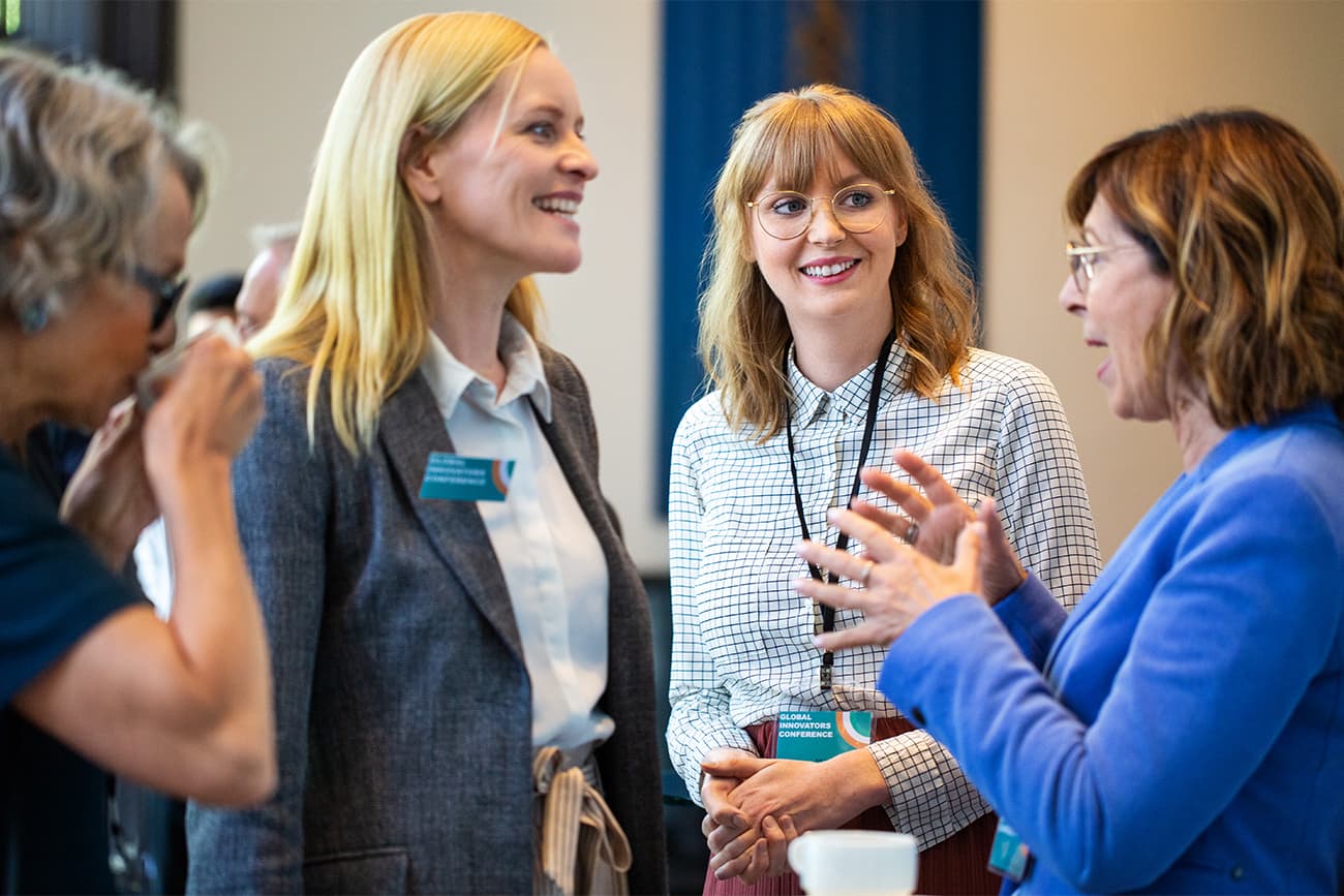 Group of women talking at a conference Group of women talking at a conference