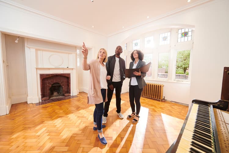 House hunting couple with agent in vintage home House hunting couple with agent in vintage home