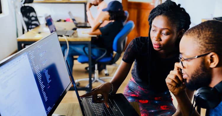 Man and woman collaborating at a desktop computer