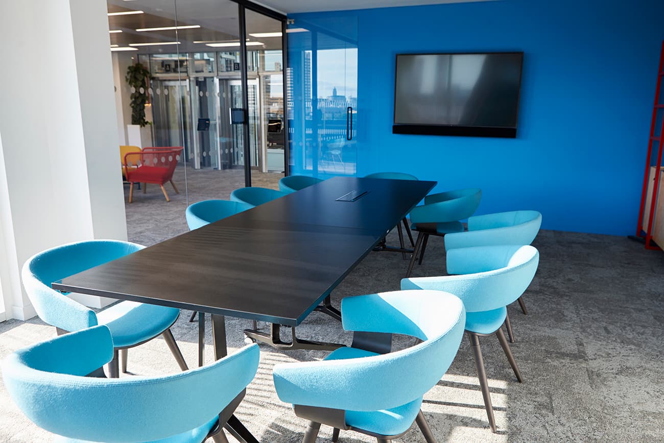 Meeting room with a table and blue chairs Meeting room with a table and blue chairs