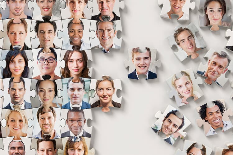 Multicultural faces as puzzle pieces Multicultural faces as puzzle pieces