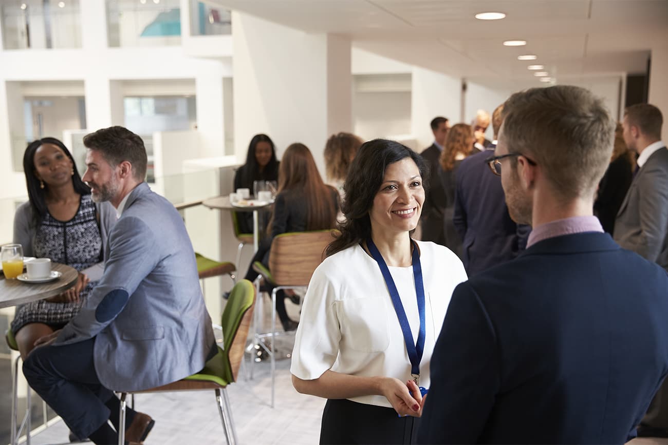 People networking at a conference People networking at a conference