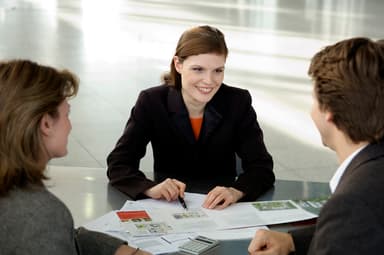 Real estate agent at table with clients Real estate agent at table with clients
