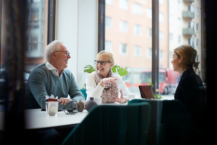 Senior couple at a table with a young woman Senior couple at a table with a young woman