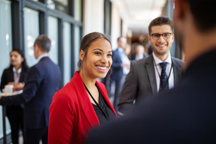 Woman in red blazer talking to colleagues Woman in red blazer talking to colleagues