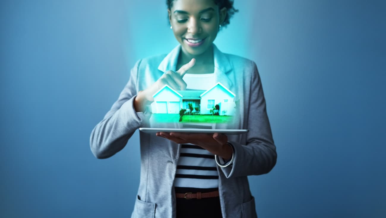 A Woman holding a holographic house in her hands, and smiling