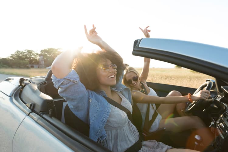 Women on road trip in convertible Women on road trip in convertible