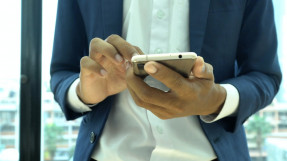 Hands holding a smart phone in a professional setting