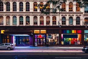 Shopping district storefront decorated for Pride week 