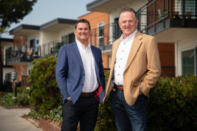 Jeff Bosshard and Scott Pritchett in front of apartment buildings for Commercial Connections Fall issue