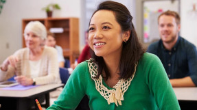Smiling young woman in an adult education classroom