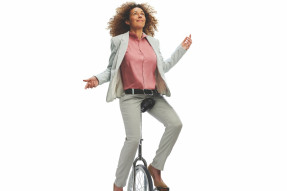 Business woman juggling work/life balance on cycle 