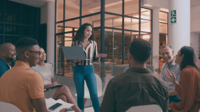 Business woman leading casual team meeting in office