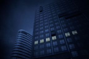 Dark blue skyscraper building symbolizing commercial real estate