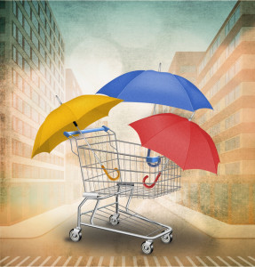 Insurance concept, umbrellas in shopping cart