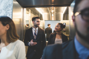 Multi-ethnic business executives exiting an elevator