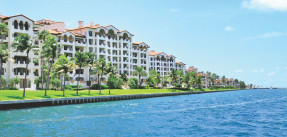 Multi-family housing on the water with palm trees