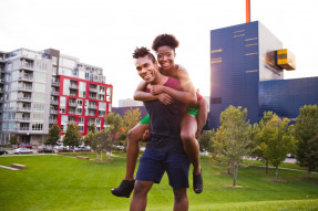 Young man and woman having fun in outdoor park city area