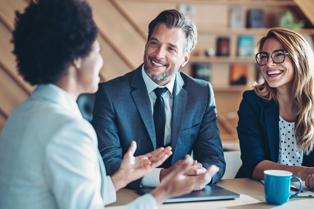 A group of REALTORS® talking to one another