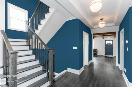 Blue hallway and stairwell with white accent. 