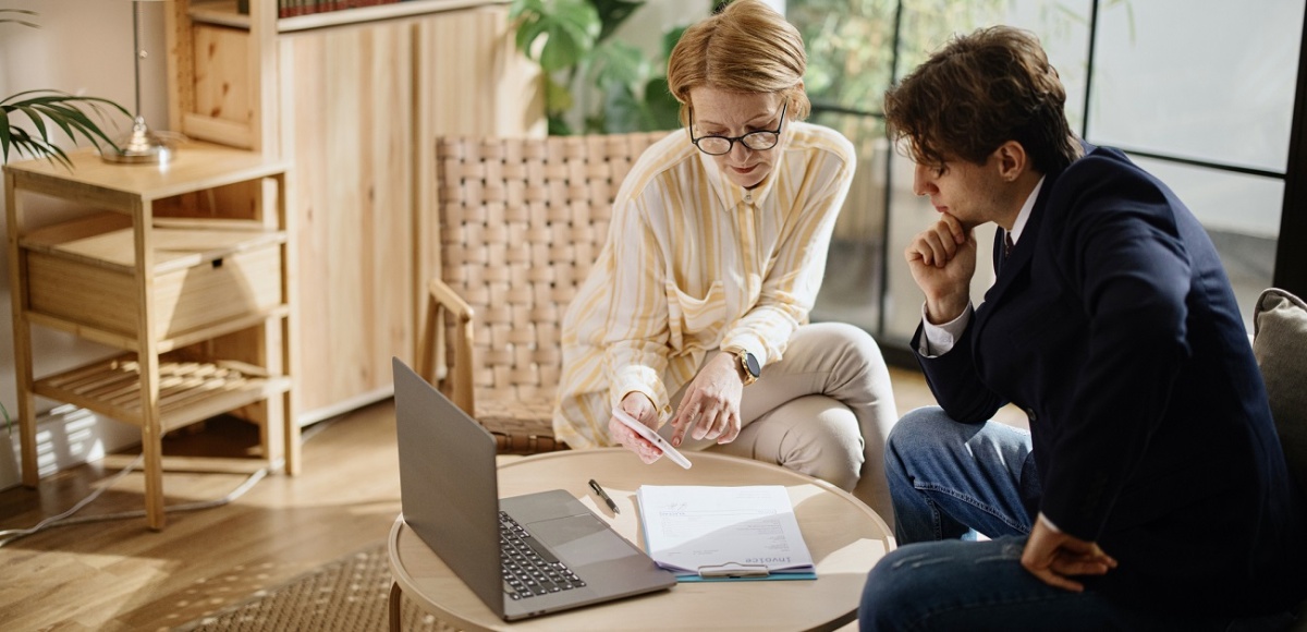 real estate agent reviewing profit goals with investor client