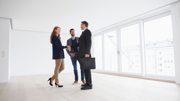 Real estate agent with couple in condo