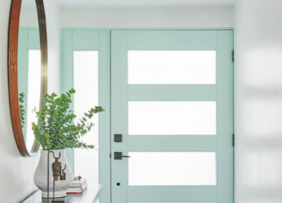 Entry way with light blue painted door, side table and mirror