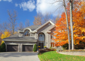 Large stone house with two-car garage in autumn