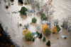 An aerial view of houses surrounded by flood water.