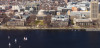 An aerial photograph showing a commercial area in a city, with buildings along the waterfront.