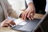 Hands on laptop keyboard touching, preventing sexual harassment concept